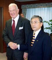 U.S. Ambassador Foley shakes hands with Defense chief Saito